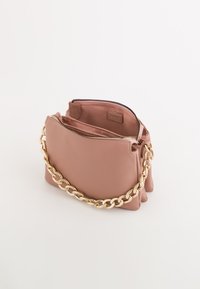 Pink leather bag with a gold chain strap, featuring a textured surface and double zip compartments for secure storage.