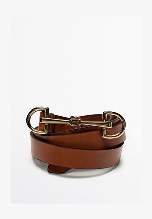 Brown leather belt with a polished gold buckle, featuring a sleek design and smooth texture. The belt is coiled with pointed ends.