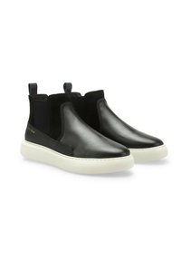 Scarpe slip-on in pelle nera con pannelli elastici ai lati, una suola in gomma bianca e dettagli verdi a contrasto sul tallone. Texture liscia complessiva.