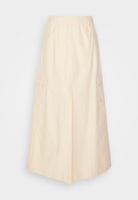 Bež kapron seelik, millel on elastne vöökoht, küljetaskud ja vabalt langev lõige. Kanga pind tundub sile ja kergelt läikiv.