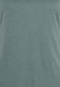 Teal lightweight T-shirt made of soft fabric, featuring a round neckline and a plain, smooth texture without patterns or accents.