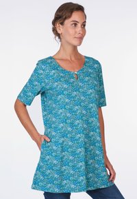 Türkisfarbener Blumen-Tunike mit kurzen Ärmeln, rundem Halsausschnitt und einem Schlüssellochdetails. Hat eine lockere Passform und seitliche Taschen.
