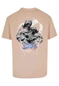 Light beige cotton T-shirt featuring a gray graphic of two figures on the back, with blue accents and stylized text above and below.