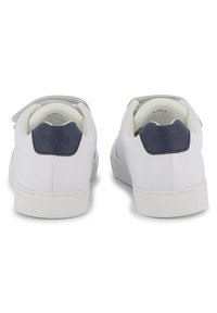 Witte sneakers met een glad leren bovenwerk, contrasterende marineblauwe hieltab en rubberen zool. Voorzien van een klittenbandsluiting voor een veilige pasvorm.