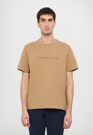 T-shirt en coton marron à manches courtes et col rond ; présente un texte en relief "MICHAEL KORS" sur le devant. Conçu pour un ajustement décontracté.