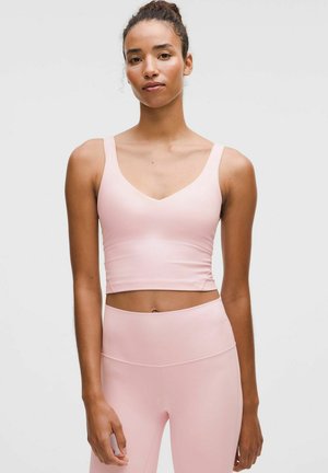 Helles rosa Sport-Crop-Top mit V-Ausschnitt, breiten Trägern und glattem, dehnbarem Stoff. Kombiniert mit passenden hochtaillierten Leggings.