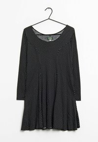 Robe noire à manches longues avec des pois blancs, décolleté arrondi et ourlet évasé. Fabriquée en tissu doux avec une texture lisse.