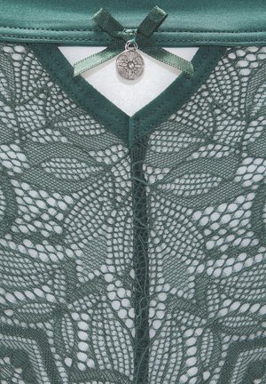 Green lace garment featuring intricate leaf patterns, finished with a satin ribbon and decorative metal charm at the neckline.