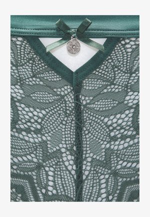 Green lace garment featuring intricate leaf patterns, finished with a satin ribbon and decorative metal charm at the neckline.