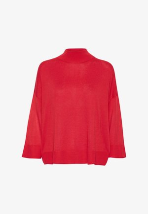 Pull à col roulé en tricot rouge, avec une coupe ample, des épaules tombantes et des accents côtelés aux poignets et à l'ourlet. Texture légère.