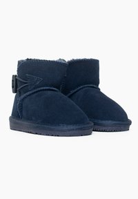 Stivaletti alla caviglia blu navy realizzati in suede con un interno morbido, dotati di un fiocco decorativo laterale e una suola in gomma testurizzata.