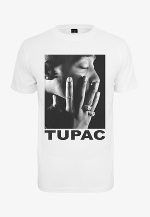 Biała bawełniana koszulka z dużym czarno-białym portretem osoby z pierścionkami na palcach oraz napisem "TUPAC" dużymi czarnymi literami.