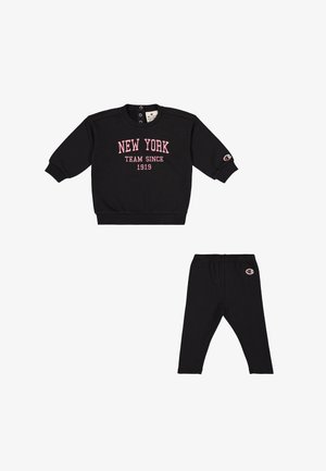 Zwarte sweatshirt met roze tekst 'NEW YORK TEAM SINCE 1919', ronde hals en drukknopen, gecombineerd met zwarte leggings met logo.