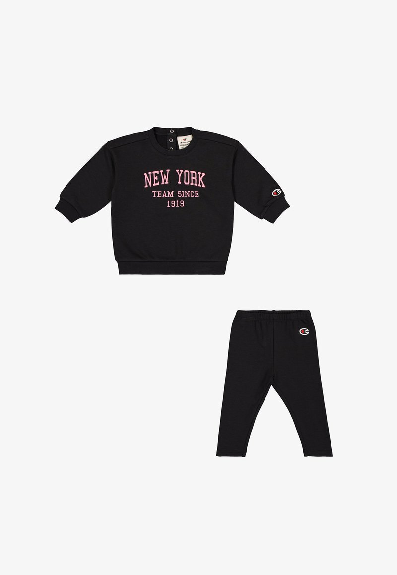 Black sweatshirt with pink 'NEW YORK TEAM SINCE 1919' text, crew neck, and snap button details, paired with black leggings featuring logo.