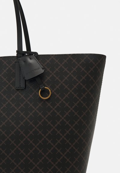 Black tote bag with textured surface, featuring a diamond pattern in dark brown, leather accents, and a gold metal ring detail.