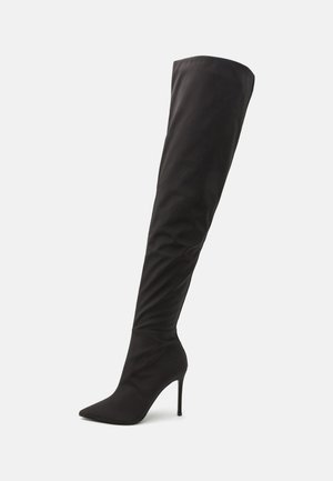 Black over-the-knee boot made of smooth fabric, featuring a pointed toe and slim, high stiletto heel with a sleek, fitted silhouette.
