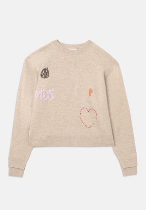 Beige kort genser med broderte detaljer. Har forskjellige fargerike lapper, inkludert tekst og et hjerte-design. Ribbestrikkede mansjetter og hem.