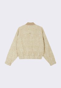 Veste bomber beige avec un motif artistique fait de lignes blanches continues, ourlet élastique et col côtelé. Texture douce, design décontracté.