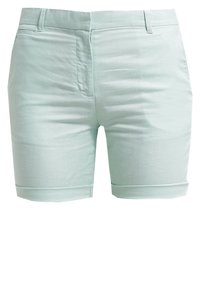 Shorts vert menthe clair en tissu texturé, avec un ourlet roulé, des poches avant et une taille classique.