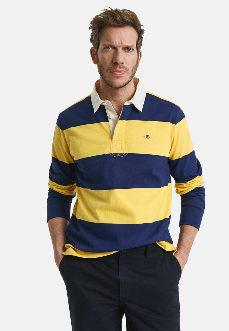 Langärmliges Poloshirt mit breiten gelben und marineblauen Streifen, einem weißen Kragen und gesticktem Logodetail auf der linken Brust.