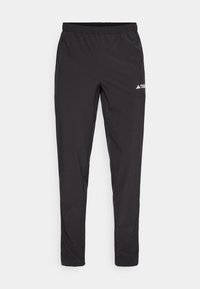 Pantalon de sport noir avec taille élastique et poches latérales zippées, orné d'un petit logo blanc sur la cuisse droite.