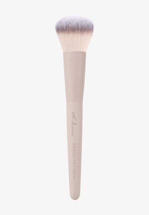 Makeup brush with soft, dense, light-colored bristles and a beige handle labeled "Curve 216 Full Face Brush."