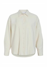 Camisa de botón de color crema claro con cuello, de corte oversized y mangas largas. Textura suave, dobladillo redondeado, con detalles sutiles de botones.
