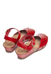 Red leather sandals with perforated floral design, adjustable ankle strap, cushioned insole, and textured rubber outsole.