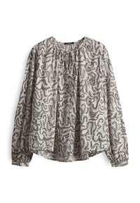 Long-sleeve blouse in light beige with black abstract pattern. Features a gathered neckline and loose fit, made from lightweight fabric.