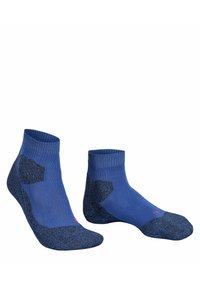 Calcetines tobilleros azules con puños acanalados y zonas de talón y puntera en texturizado azul oscuro. Presentan pequeños detalles rojos en el costado.