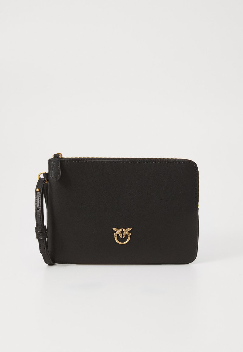 Black leather clutch with a smooth texture, rectangular shape, gold-tone logo detail, top zipper closure, and detachable wrist strap.