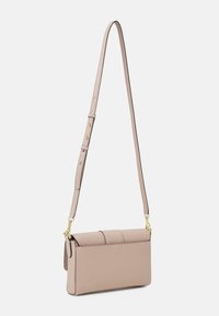 Light pink rectangular crossbody bag with textured leather, adjustable strap, and gold-tone hardware. Features a fold-over flap with stitching detail.