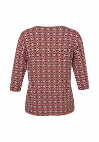 Haut à motifs losanges rouges avec des manches trois-quarts, col rond et texture de tissu lisse. Design géométrique sur un fond clair.