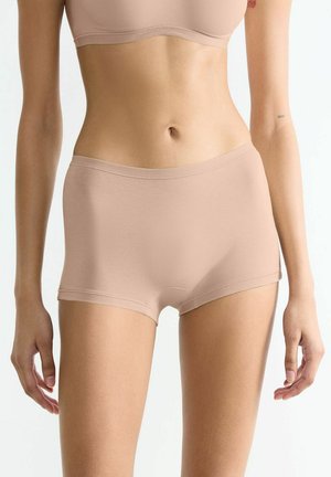 Nude cotton blend boxer briefs with a smooth texture, seamless sides, and an elastic waistband, offering a close fit.