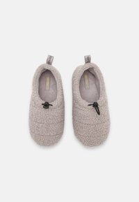 Gray, textured fleece slippers with a rounded shape and elastic drawstring. Features a soft inner lining and looped fabric exterior.