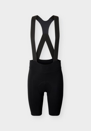 Juodi dviračių kombinezono šortai su paminkštinta sėdyne ir elastinėmis petnešomis, pateikti ant šviesaus fono.