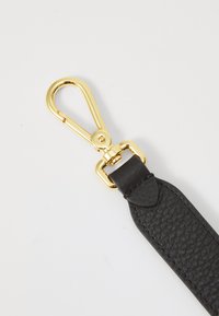 Black textured leather strap with a gold-colored metal clasp and hardware, featuring a rounded end with a smooth finish.