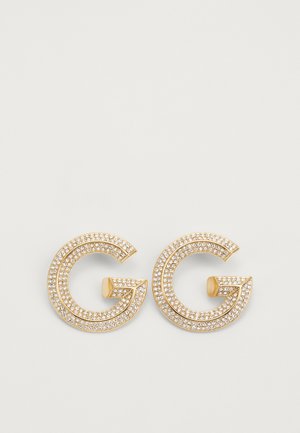 Gold-tone earrings featuring double "G" design, adorned with clear crystals for texture and shine, creating a bold visual statement.