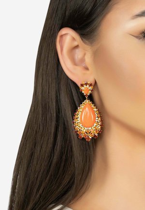 Orange teardrop earrings with rhinestone embellishments; features a floral-shaped top piece; gold-tone metal accents; textured surfaces.