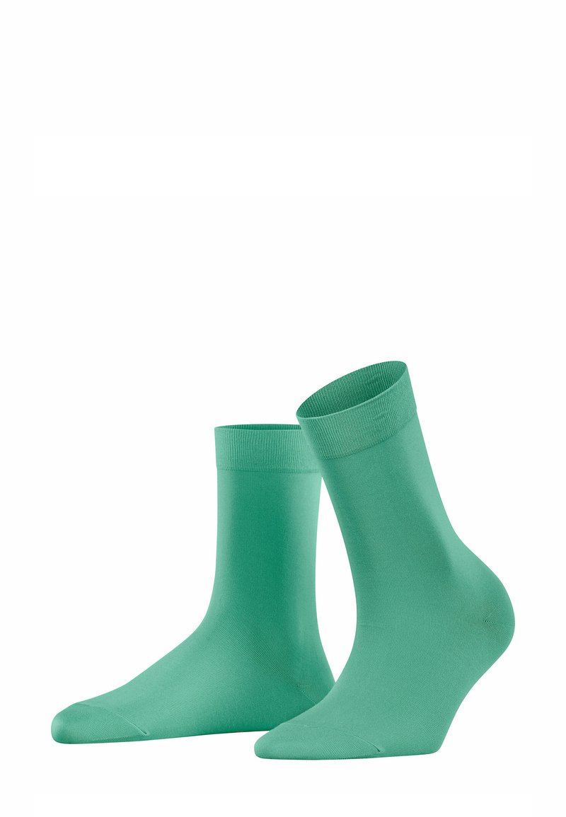 Türkise Baumwollsocken mit glatter Textur, knielangem Design und geripptem Bündchen. Charakteristisch ist die einheitliche Farbe ohne Muster oder Verzierungen.