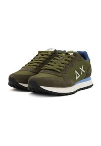 Green sneakers made of suede and textile, featuring a white logo, black rubber sole, and blue accents on the heel and tongue.