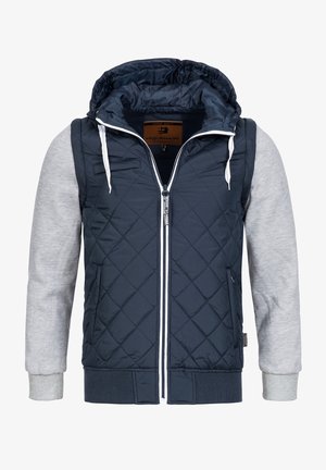 Navy quilted jacket with gray sleeves, a hood, white zipper, and drawstrings; features ribbed cuffs and hem for added texture.