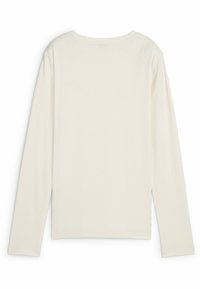 Dlouhý rukáv, ribbed top v barvě off-white. Vyznačuje se uvolněným střihem s kulatým výstřihem, bočními rozparky a měkkou, texturovanou tkaninou.