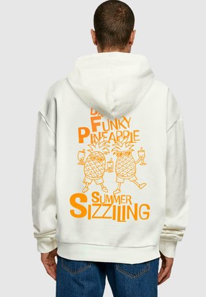 White hoodie with oversized fit featuring orange graphic of two pineapples holding drinks, with the text "DR. FUNKY PINEAPPLE SUMMER SIZZLING."