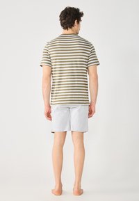 Striped, olive-green and white cotton t-shirt paired with grey cotton shorts, featuring a relaxed fit and casual design.