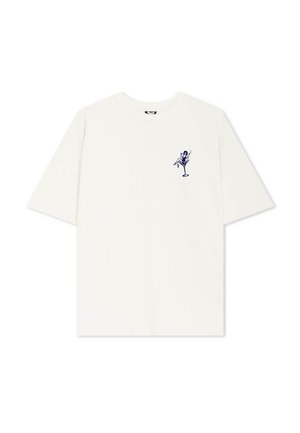 Krém színű, rövid ujjú póló, amelyen egy sötétkék grafika látható, egy ülő alakot ábrázol, italával a bal mellkas területén. Puha anyagú, laza szabású.