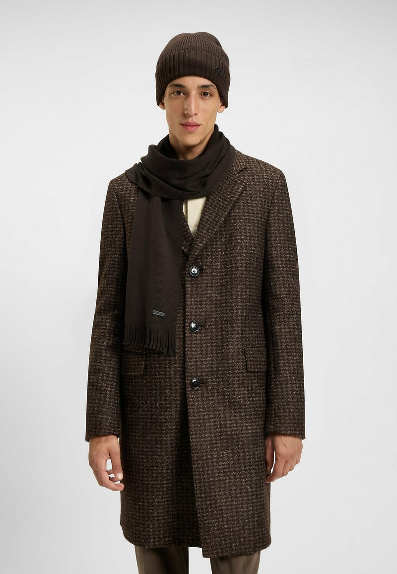 Brown patterned wool overcoat with notched collar, three buttons, and two side pockets, paired with a matching dark brown knit hat and scarf.