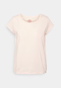 T-shirt a maniche corte, collo rotondo, in cotone rosa chiaro con una vestibilità rilassata e un discreto logo sull'orlo. Tessuto morbido, design minimale.