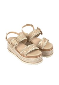 Sandali con zeppa beige, con cinturini intrecciati, dettaglio a fibbia circolare e pianta in stile espadrille texturizzata. Soletta leggera e liscia, cinturino alla caviglia regolabile.