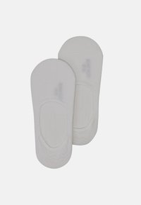 White cotton no-show socks with a smooth texture, rounded toe, and elasticized edges for a secure fit. Subtle branding on the side.